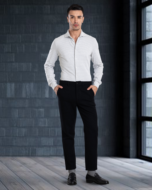 Side profile of model wearing custom wool Chino pants for men by Luxire in black hand in pockets
