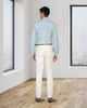 Back view of model wearing custom Genoa Chino pants for men by Luxire in ivory cream