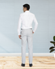 Back view of model wearing custom Genoa Chino pants for men by Luxire in light grey hand in pocket