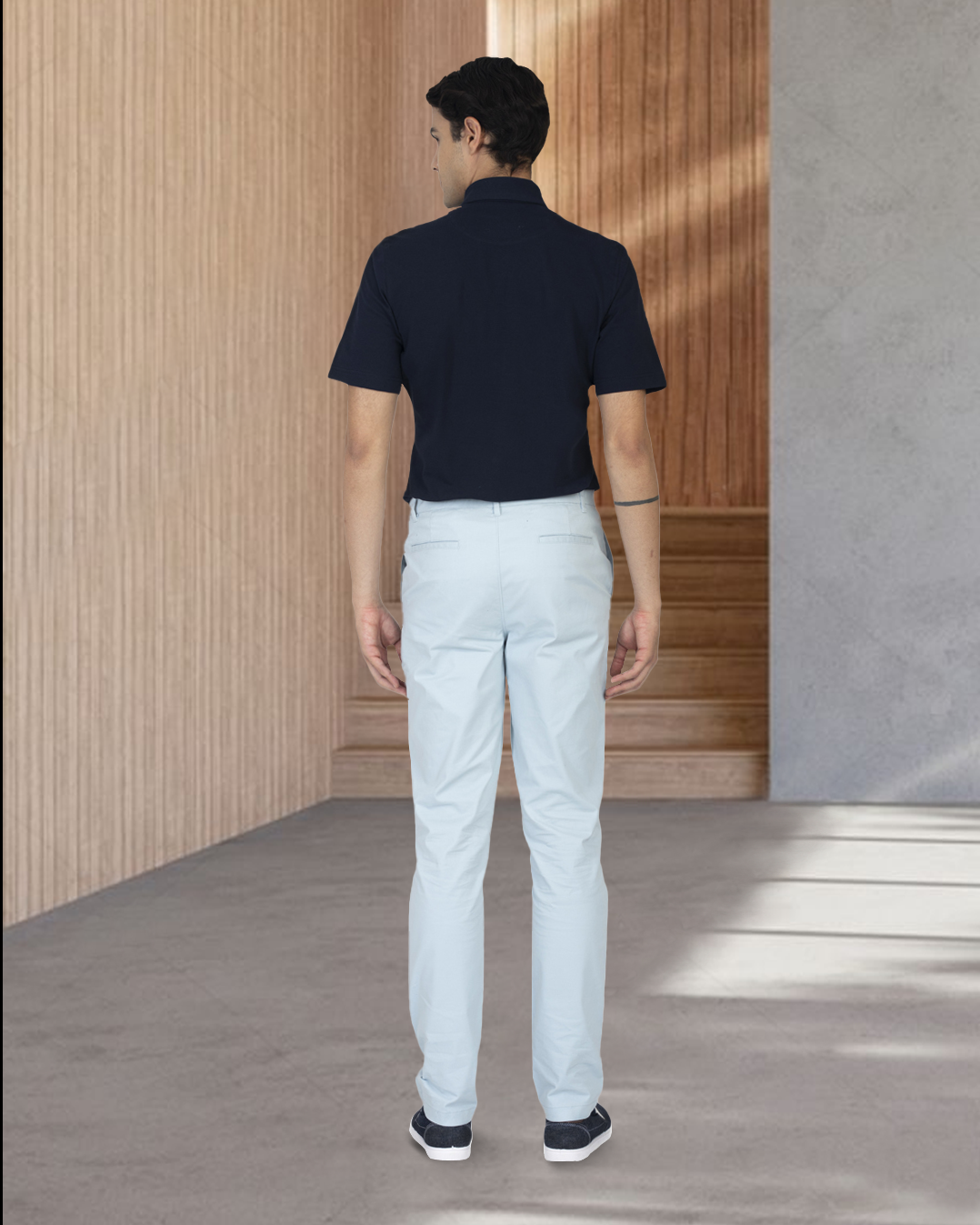 Back view of model wearing custom Genoa Chino pants for men by Luxire in powder blue