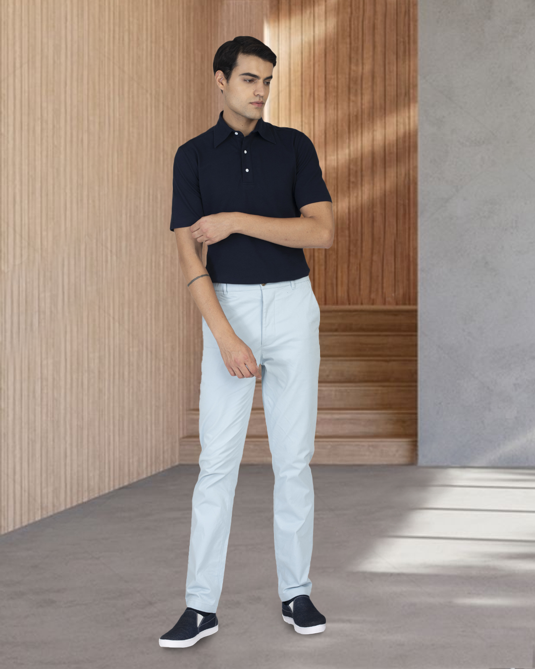 Model wearing custom Genoa Chino pants for men by Luxire in powder blue one hand down one up