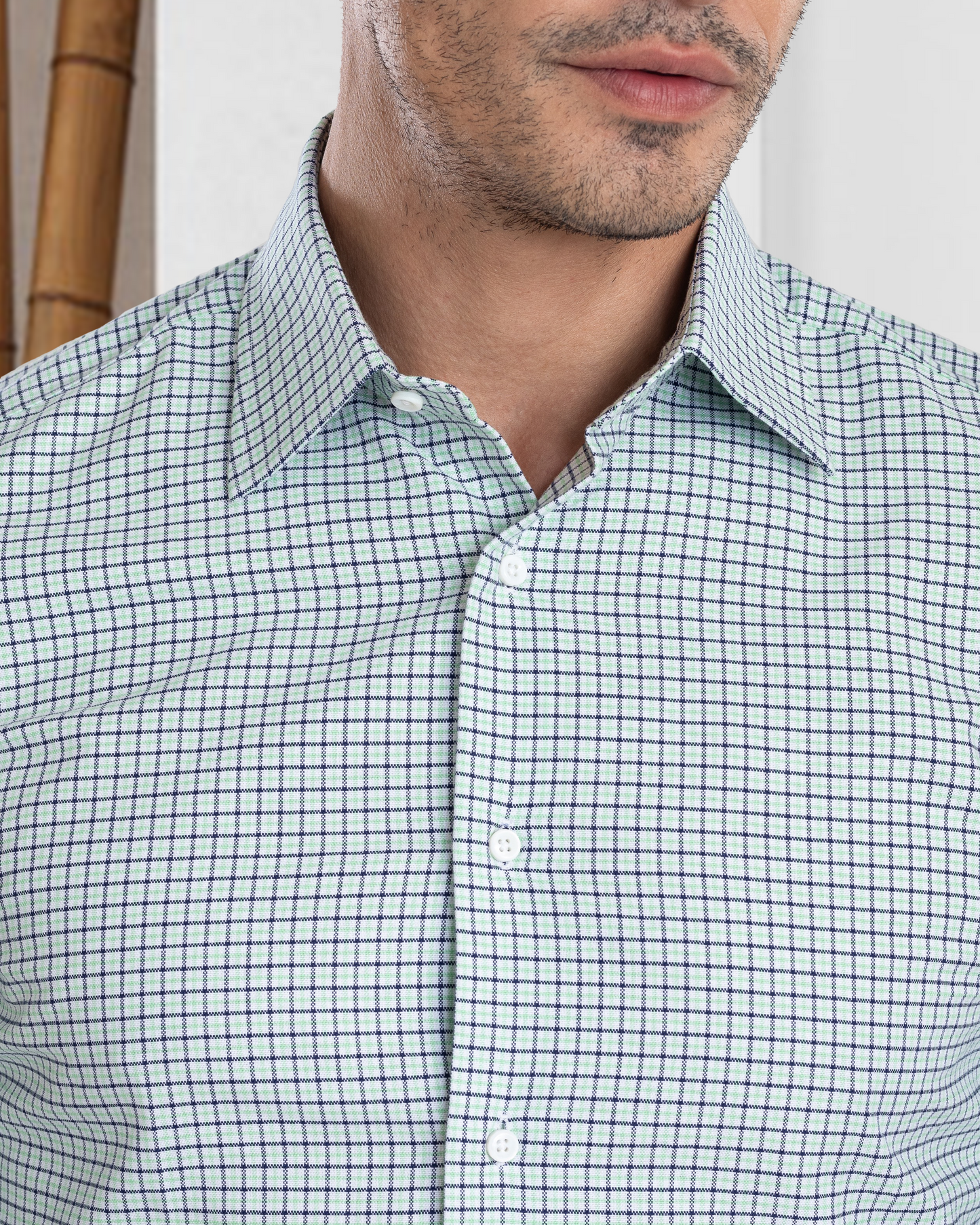 Model close up wearing custom check shirts for men by Luxire in green blue tattersall