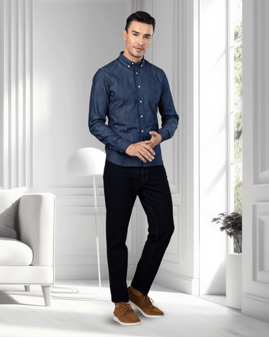 Model wearing mens fade washed jeans by Luxire in dark indigo