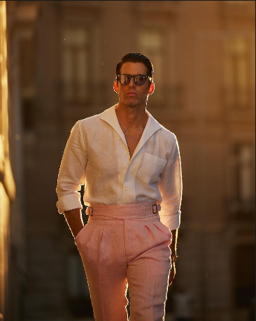 Male model wearing custom linen Gurkha pants for men by Luxire in pink twill