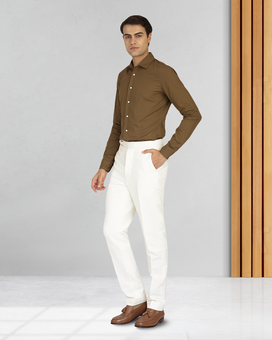 Male model wearing custom linen canvas pants for men by Luxire in white with hand in pocket