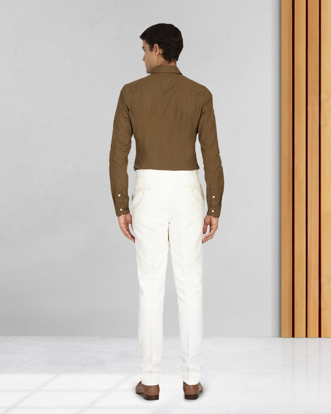 Back profile of male model wearing custom linen canvas pants for men by Luxire in white