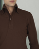 Close up of model wearing the custom oxford polo shirt for men by Luxire in brown pique