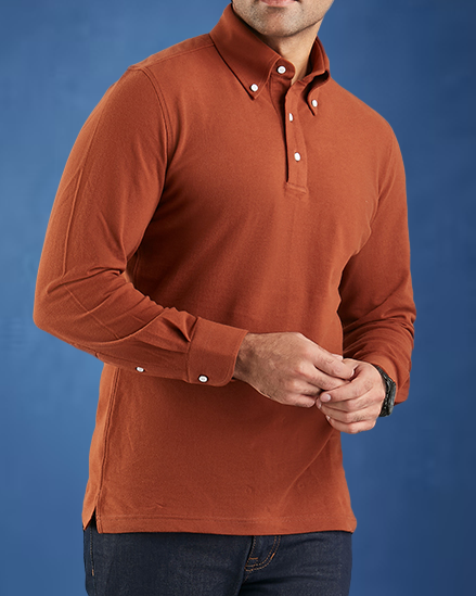 Model wearing the custom oxford polo shirt for men by Luxire in copper hands together