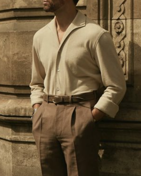 Model wearing the custom oxford polo shirt for men by Luxire in heather cream hands in pockets