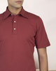 Close up of model wearing the custom oxford polo shirt for men by Luxire in soft marsala