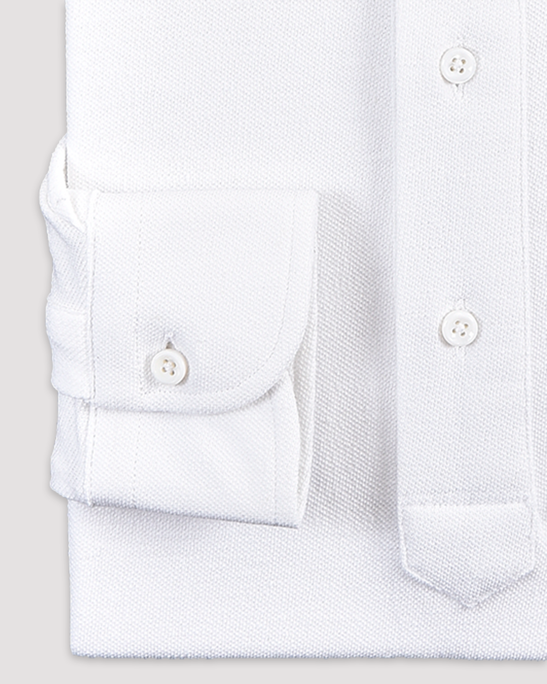 Cuff of the custom oxford polo shirt for men by Luxire in pure white