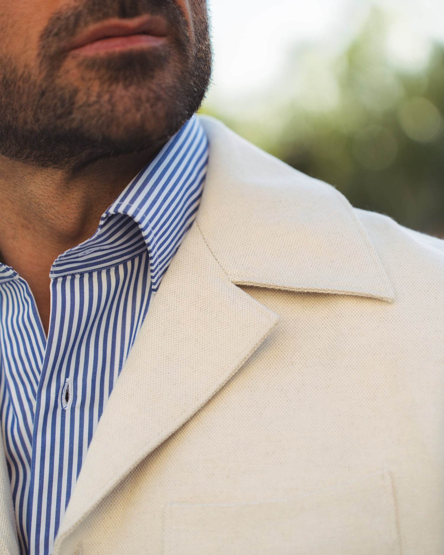 Close up of model outside wearing the linen shirt jacket for men by Luxire in cream