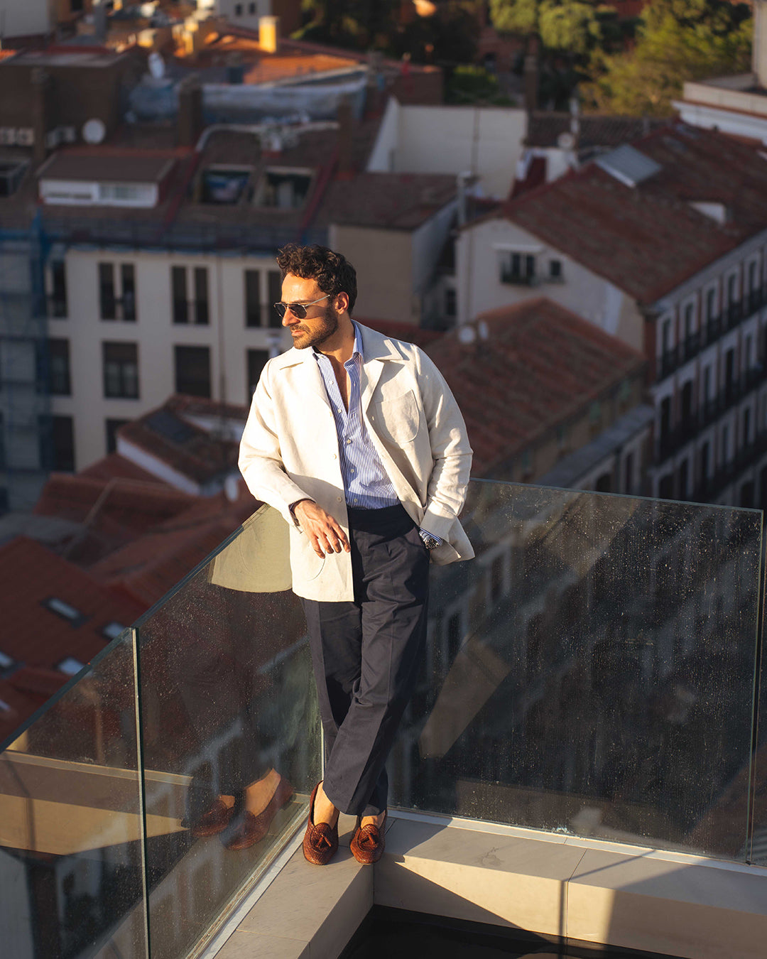 Model outside wearing the linen shirt jacket for men by Luxire in cream wearing sunglasses 7