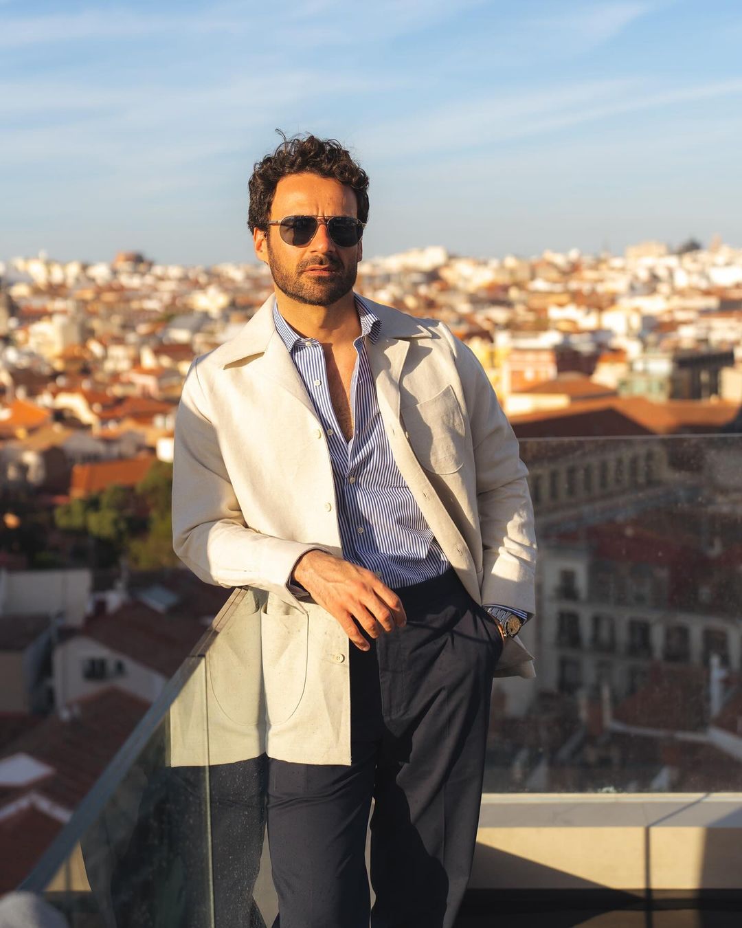 Model outside wearing the linen shirt jacket for men by Luxire in cream wearing sunglasses 2