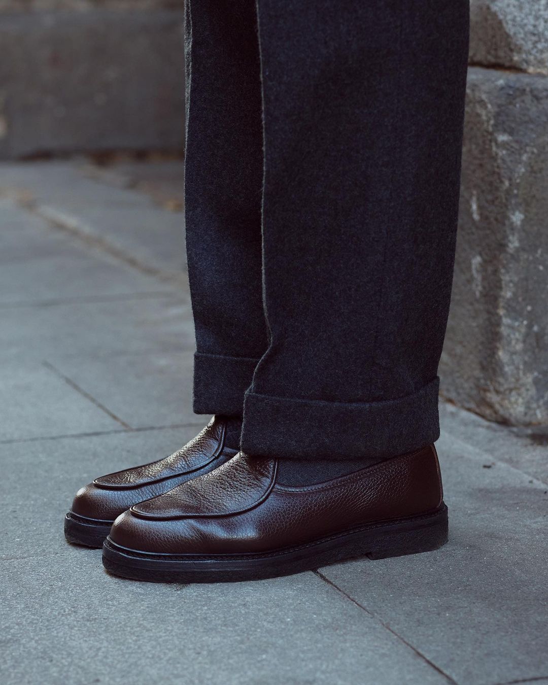 Close up of model legs and shoes wearing the recycled wool shirt jacket for men by Luxire in charcoal grey hand in pocket