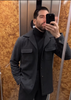 Model wearing the recycled wool shirt jacket for men by Luxire in charcoal grey taking a selfie